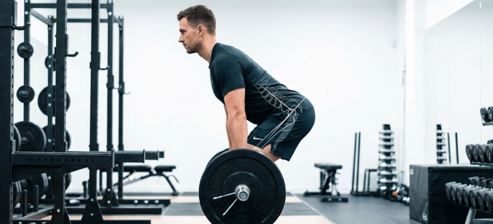 Trainer demonstrating proper deadlift form for osteoporosis prevention